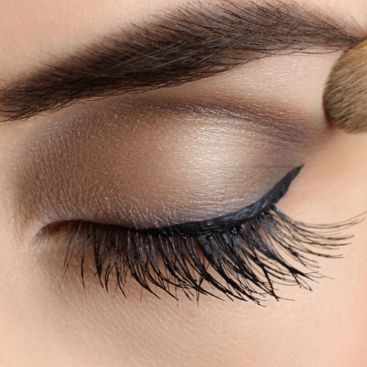 A close up of a woman 's eye with makeup.